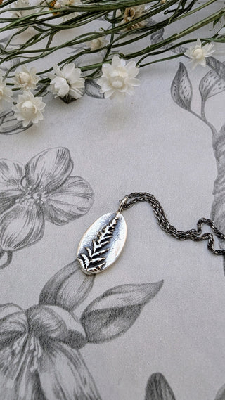 Antique silver medallion, Fern